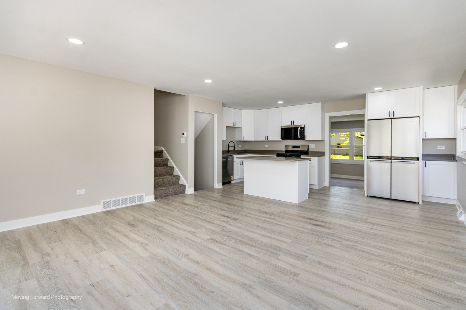 11 Durango Road Montgomery, IL 60538 - Photo 6 of 36 a view of a kitchen with wooden floor and electronic appliances