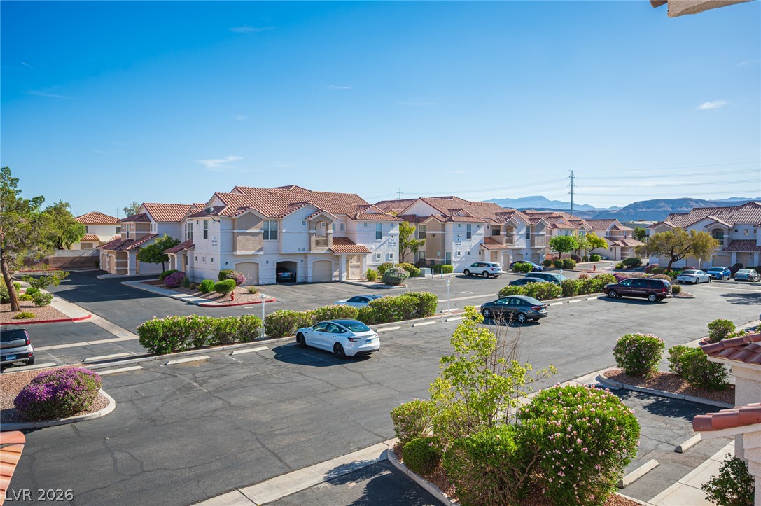 8555 West Russell Road, Unit 2062 Las Vegas, NV 89113 - Photo 32 of 35 Well-maintained community with ample parking and views of distant mountains.