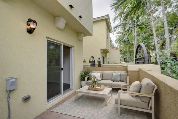 a view of a patio with couches and potted plants