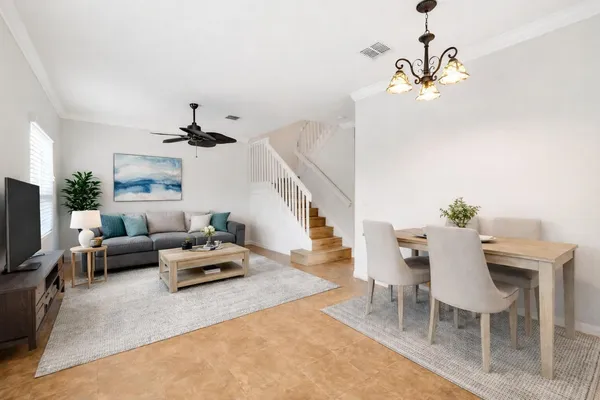 a living room with furniture and a chandelier