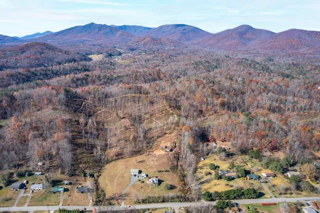 a view of a dry yard with mountains in the background