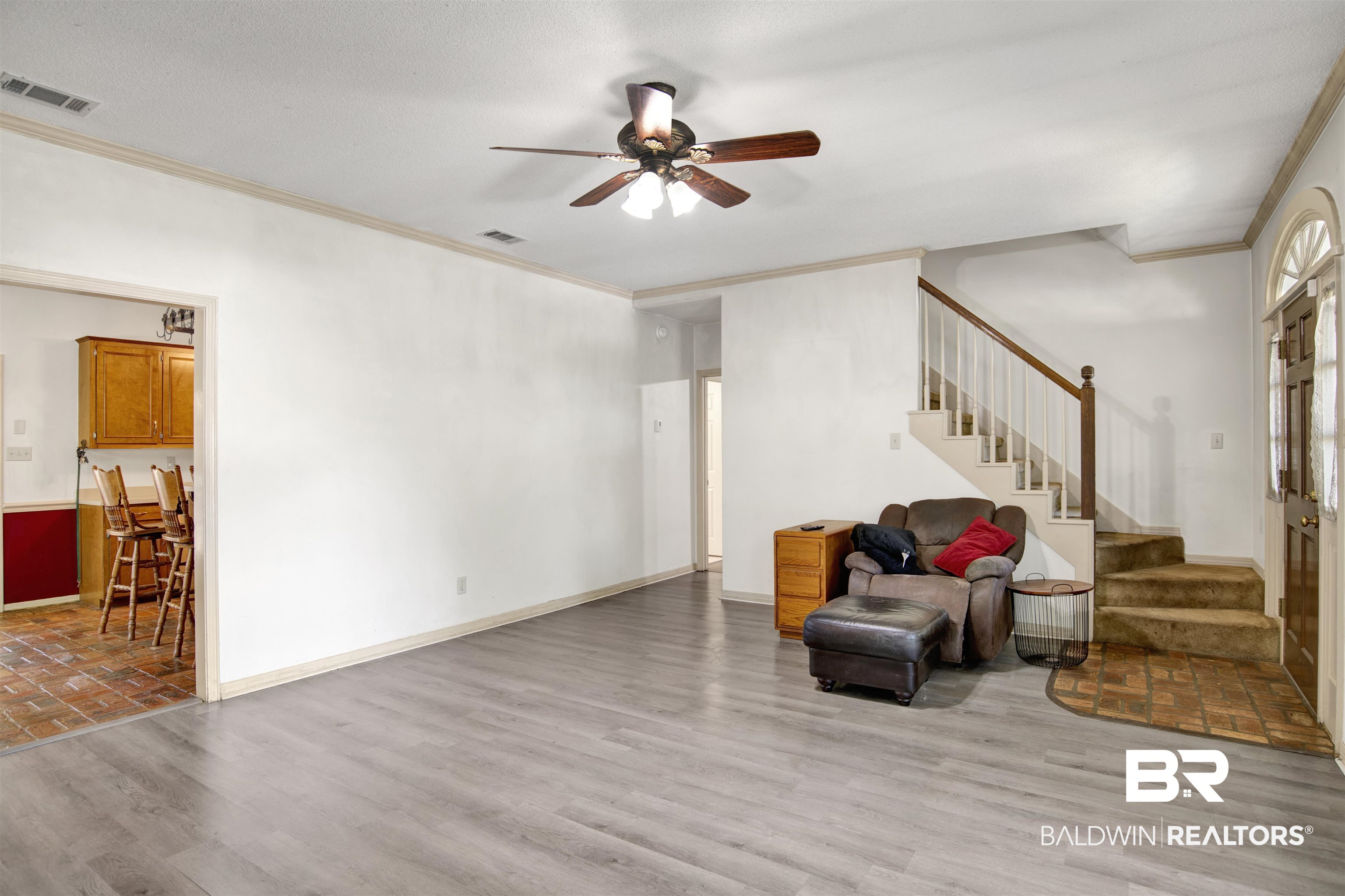 3412 Peyton Court Mobile, AL 36695 - Photo 6 of 27 Living room with crown molding, stairs, ceiling fan, wood finished floors, and baseboards