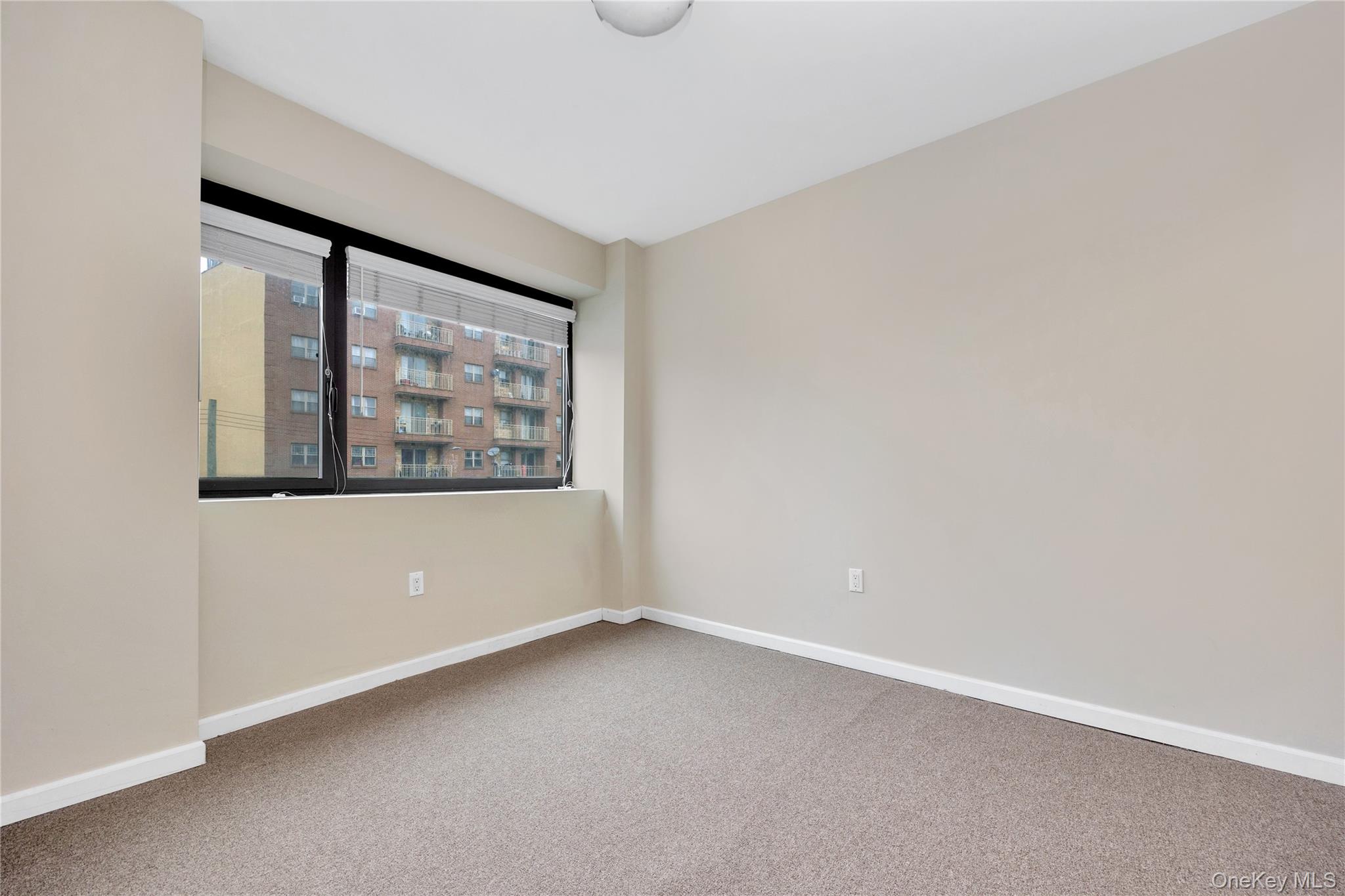 172-18 Jamaica Avenue, Unit 501 Queens, NY 11432 - Photo 6 of 27 an empty room with windows