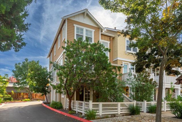 front view of a house with a tree