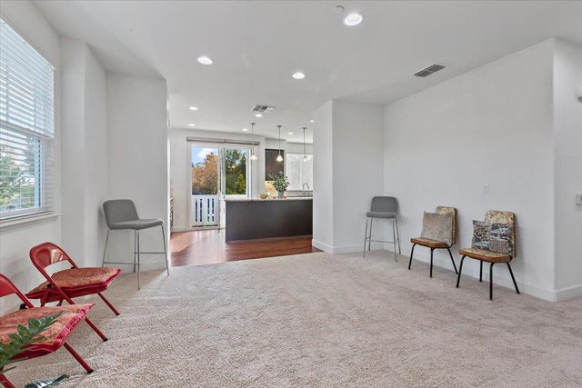 a view of a livingroom with furniture and a window