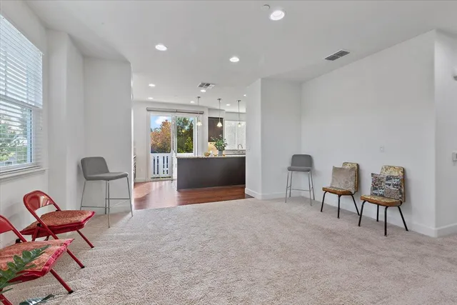 a view of a livingroom with furniture and a window