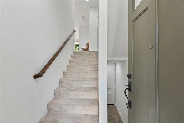 a view of staircase with white walls and stairs