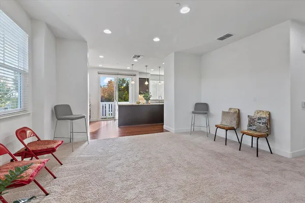 a view of a livingroom with furniture and a window