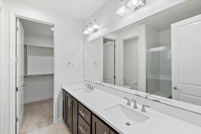 a bathroom with a sink double vanity and a mirror