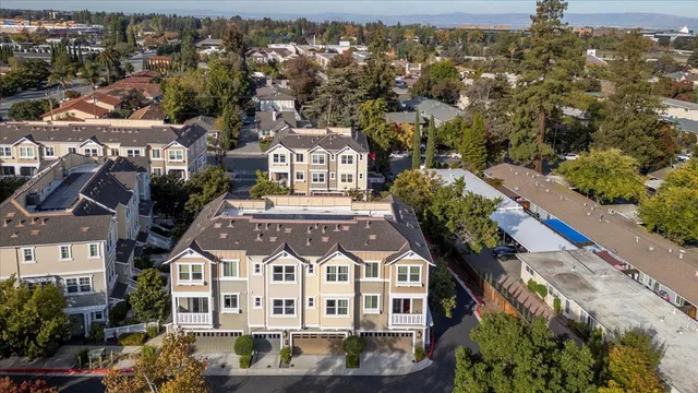 an aerial view of multiple houses with a yard