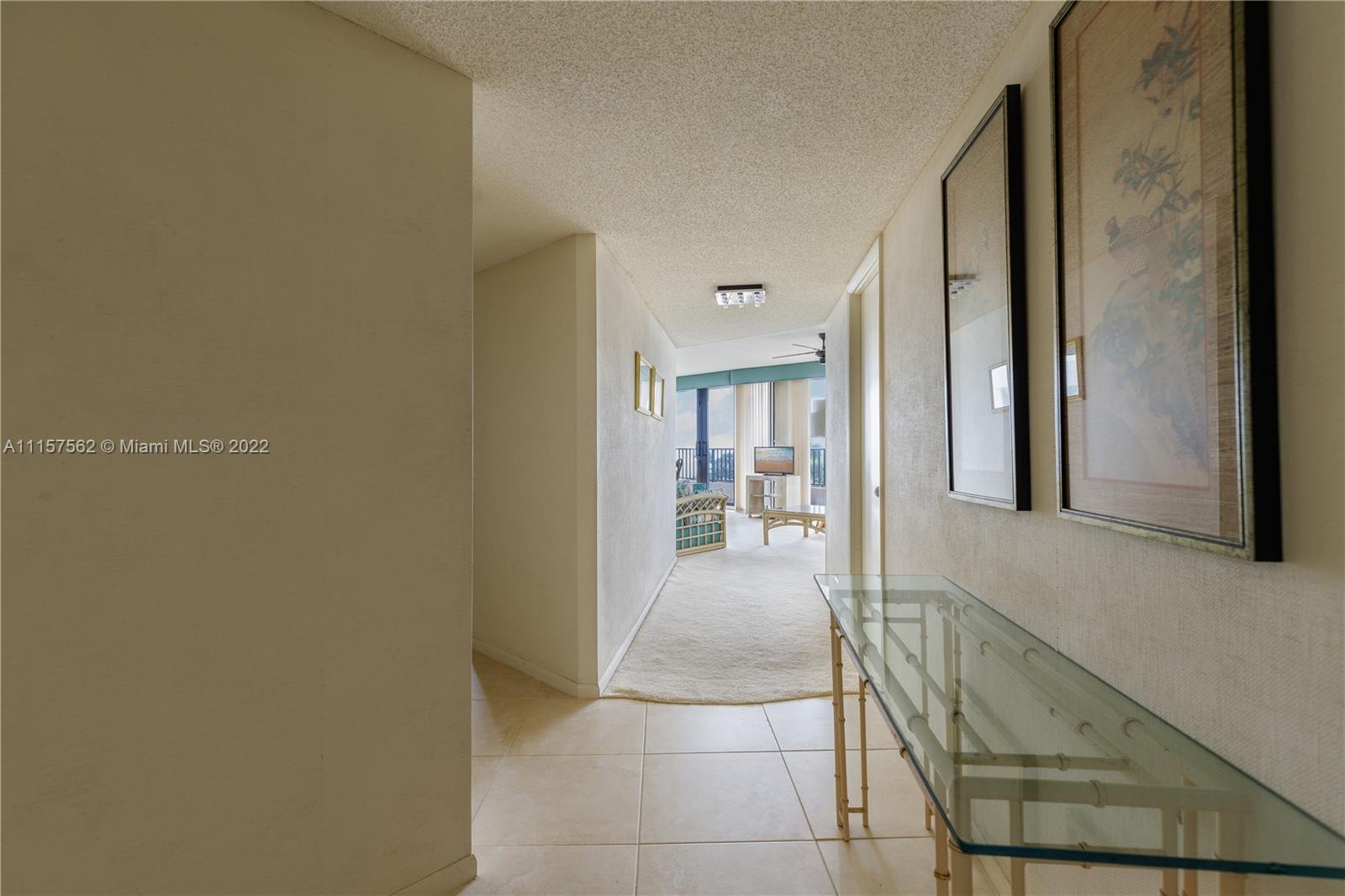 450 Ocean Drive, Unit 305 Juno Beach, FL 33408 - Photo 4 of 30 a hallway with a dining room view