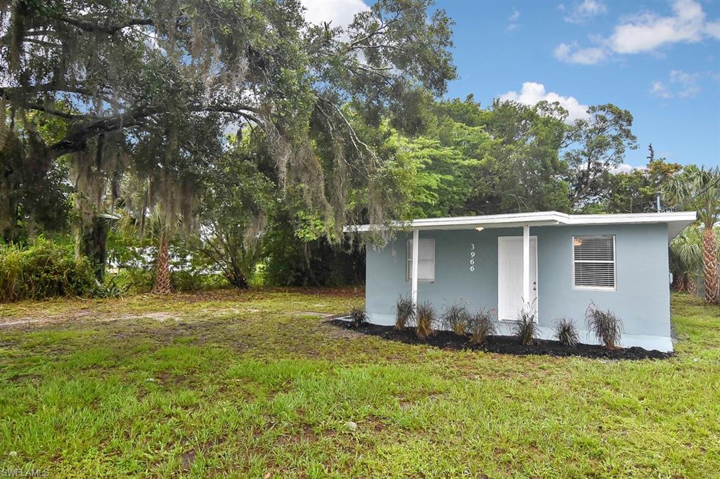 3966 Madison Avenue Fort Myers, FL 33916 - Photo 1 of 22 a backyard of a house with lots of green space