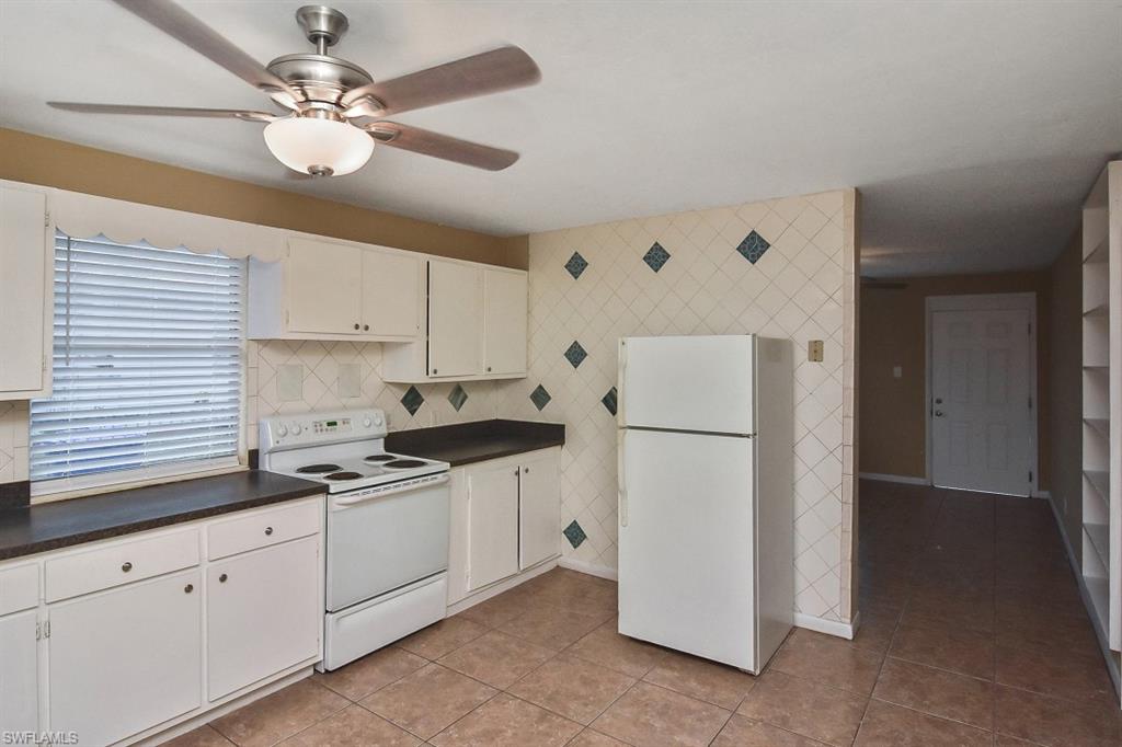 3966 Madison Avenue Fort Myers, FL 33916 - Photo 16 of 22 a kitchen with cabinets a refrigerator and a sink