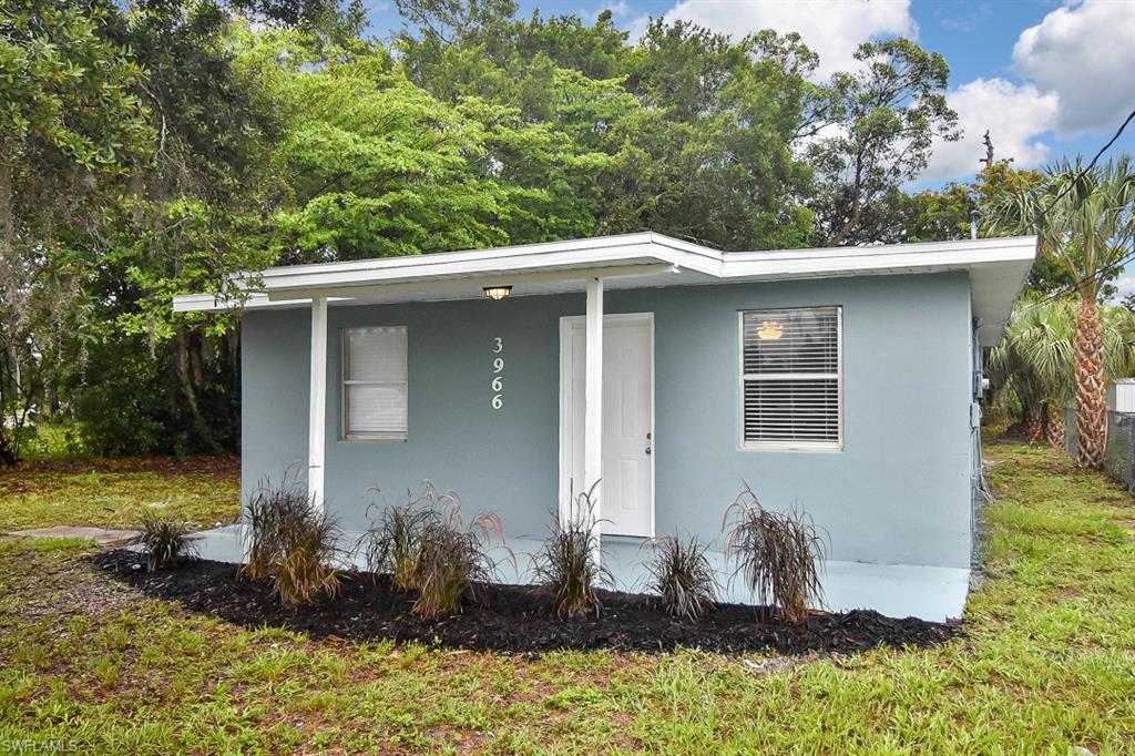 3966 Madison Avenue Fort Myers, FL 33916 - Photo 20 of 22 a front view of a house with a yard