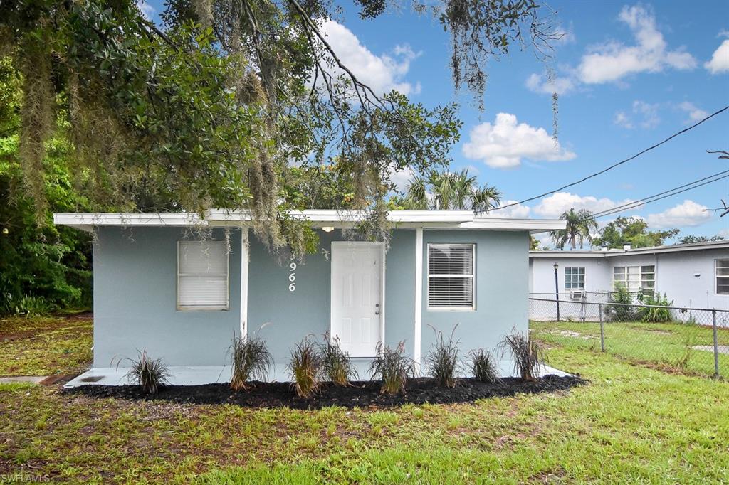 3966 Madison Avenue Fort Myers, FL 33916 - Photo 2 of 22 a front view of a house with a yard