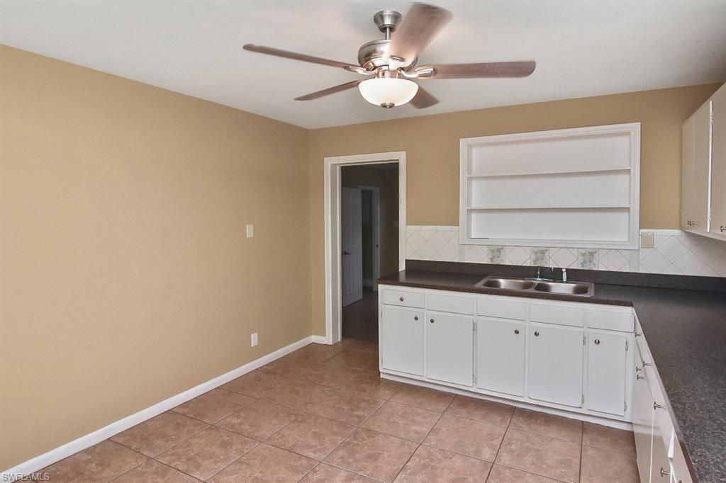 3966 Madison Avenue Fort Myers, FL 33916 - Photo 22 of 22 a kitchen with granite countertop a sink a stove and cabinets