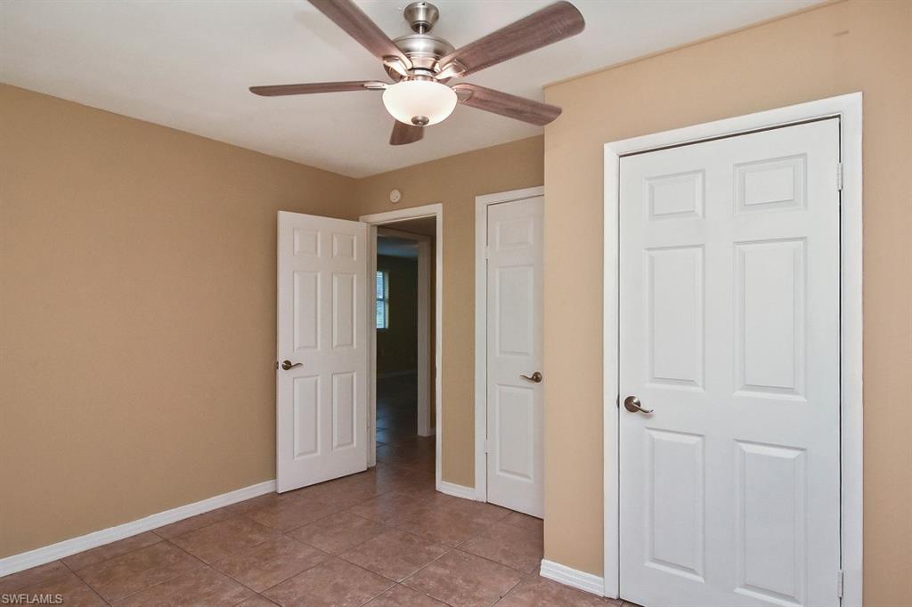 3966 Madison Avenue Fort Myers, FL 33916 - Photo 9 of 22 an empty room with a ceiling fan and a ceiling fan