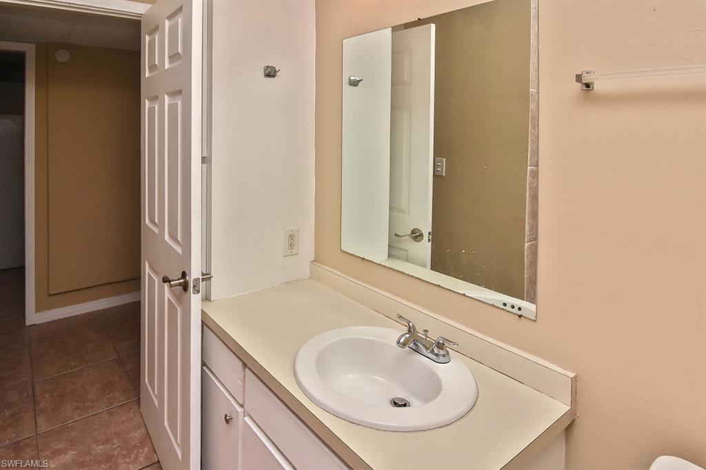 3966 Madison Avenue Fort Myers, FL 33916 - Photo 10 of 22 a bathroom with a sink and a mirror