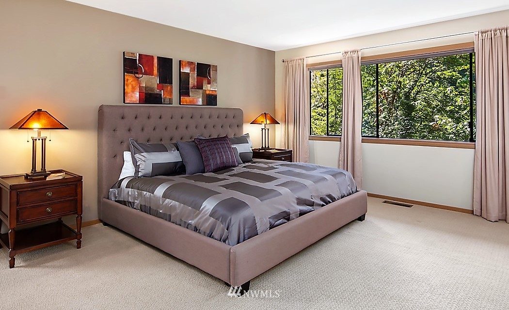 4453 East Mercer Way Mercer Island, WA 98040 - Photo 12 of 25 a bed sitting in a bedroom next to a window