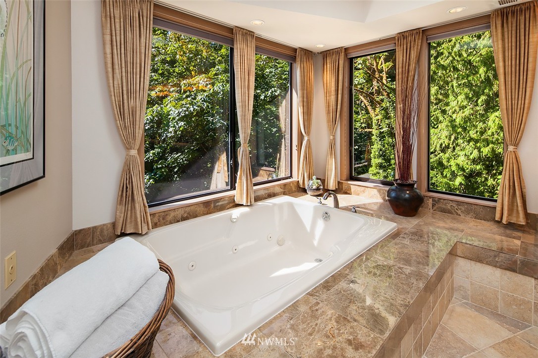 4453 East Mercer Way Mercer Island, WA 98040 - Photo 13 of 25 a large white tub sitting in front of a window