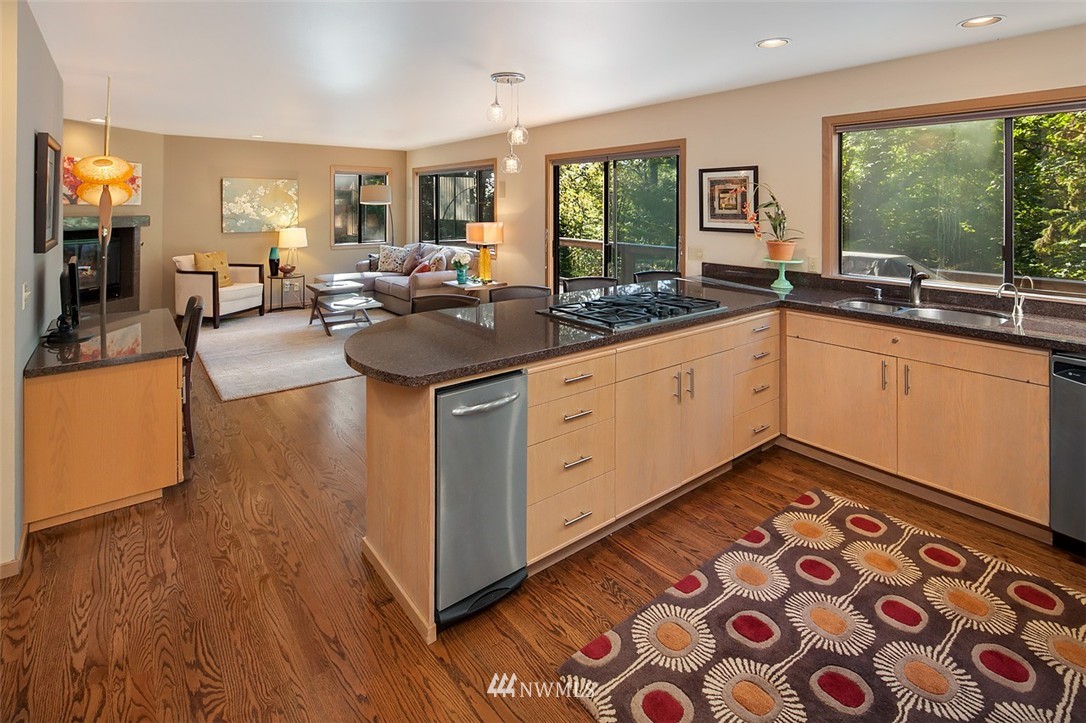4453 East Mercer Way Mercer Island, WA 98040 - Photo 7 of 25 a open kitchen with stainless steel appliances granite countertop a sink and wooden floors