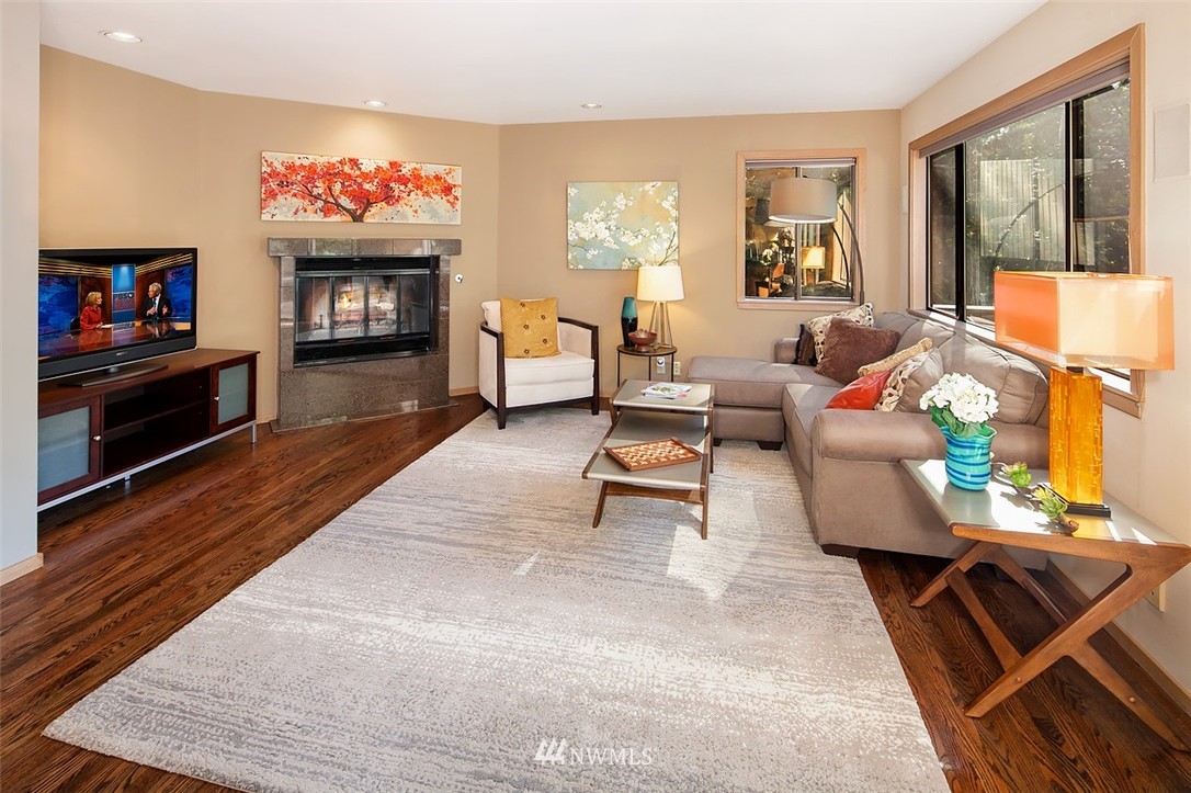 4453 East Mercer Way Mercer Island, WA 98040 - Photo 9 of 25 a living room with furniture a flat screen tv and a fireplace