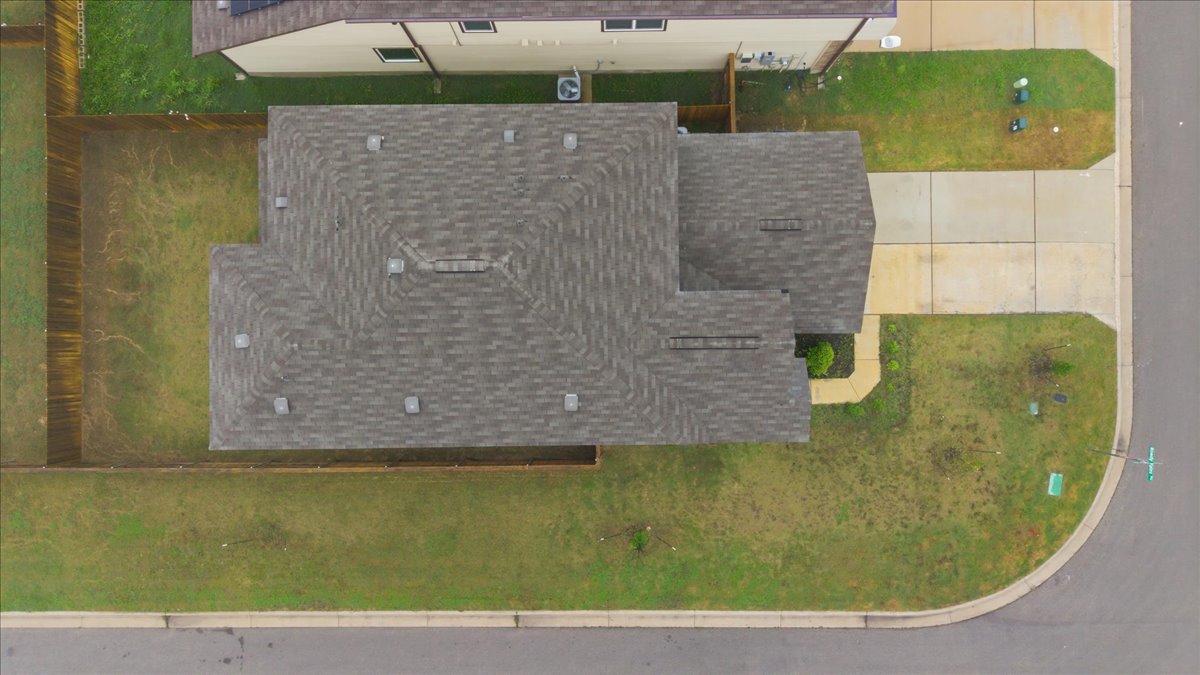 101 Rowdy Yates Way Jarrell, TX 76537 - Photo 32 of 32 Asphalt shingle roof with multiple vents and a fenced backyard