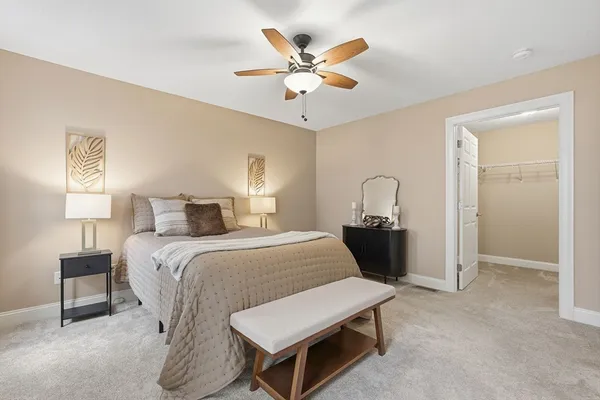 a bedroom with a bed and a ceiling fan