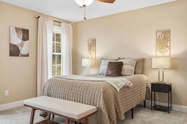 a bedroom with a bed and a lamp
