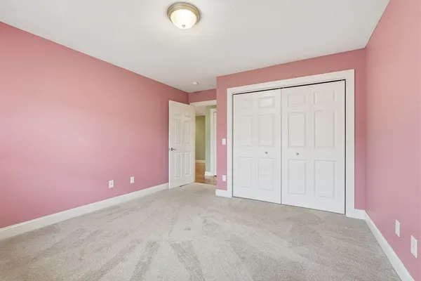 an empty room with closet area