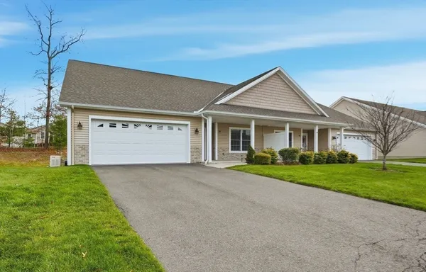 a front view of a house with a yard and garage