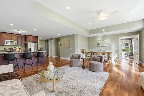 a living room with furniture kitchen and a table