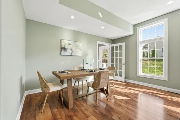 a view of a dining room with furniture and wooden floor