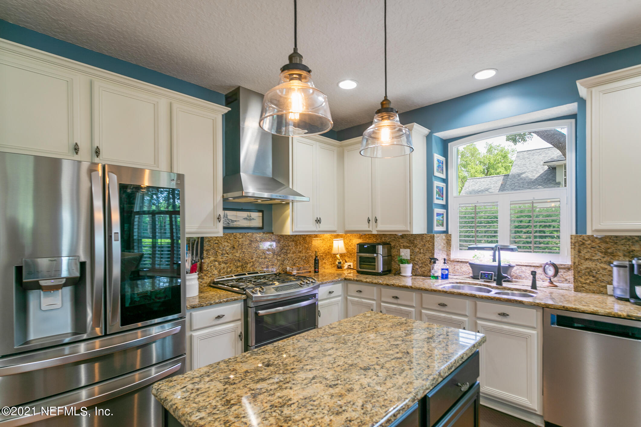 1508 Hackberry Court St. Johns, FL 32259 - Photo 11 of 47 a kitchen with stainless steel appliances granite countertop a stove a sink and a refrigerator