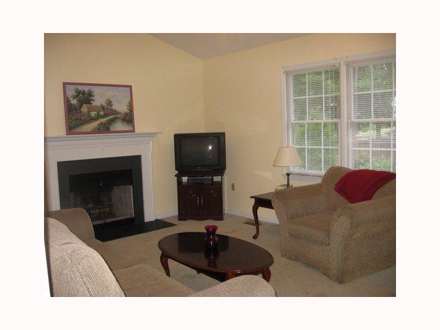 3708 Old Coach Road Raleigh, NC 27616 - Photo 4 of 7 a living room with furniture potted plant and a fireplace