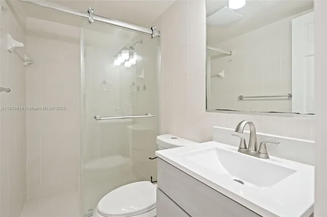 an empty room with closet and a chandelier fan