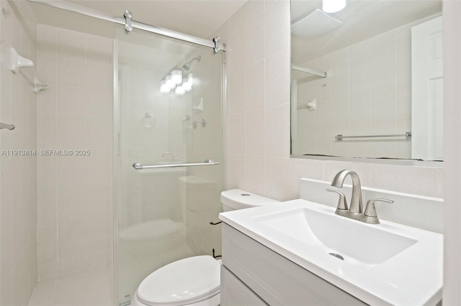 13000 Old Cutler Road Pinecrest, FL 33156 - Photo 15 of 45 a bathroom with a sink toilet and shower