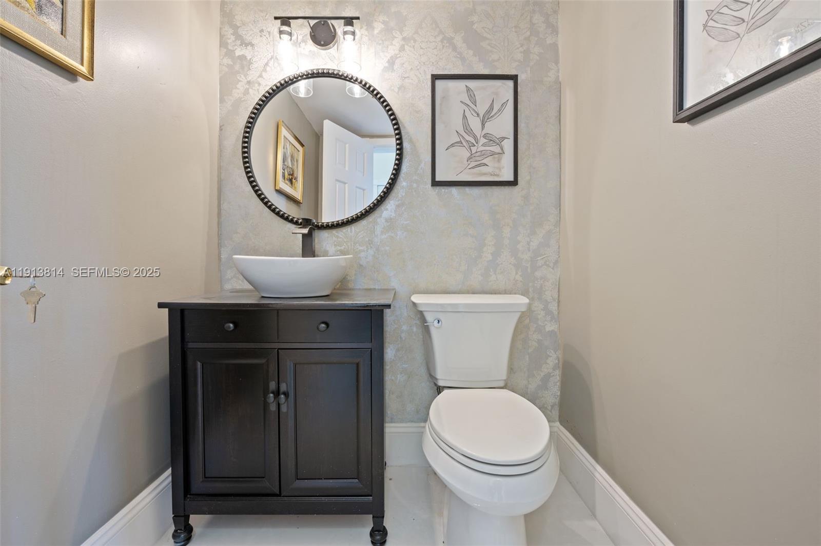 13000 Old Cutler Road Pinecrest, FL 33156 - Photo 19 of 45 a bathroom with a toilet a sink and a mirror