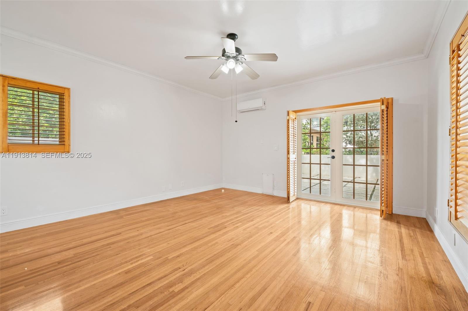 13000 Old Cutler Road Pinecrest, FL 33156 - Photo 20 of 45 a view of an empty room with wooden floor and a window