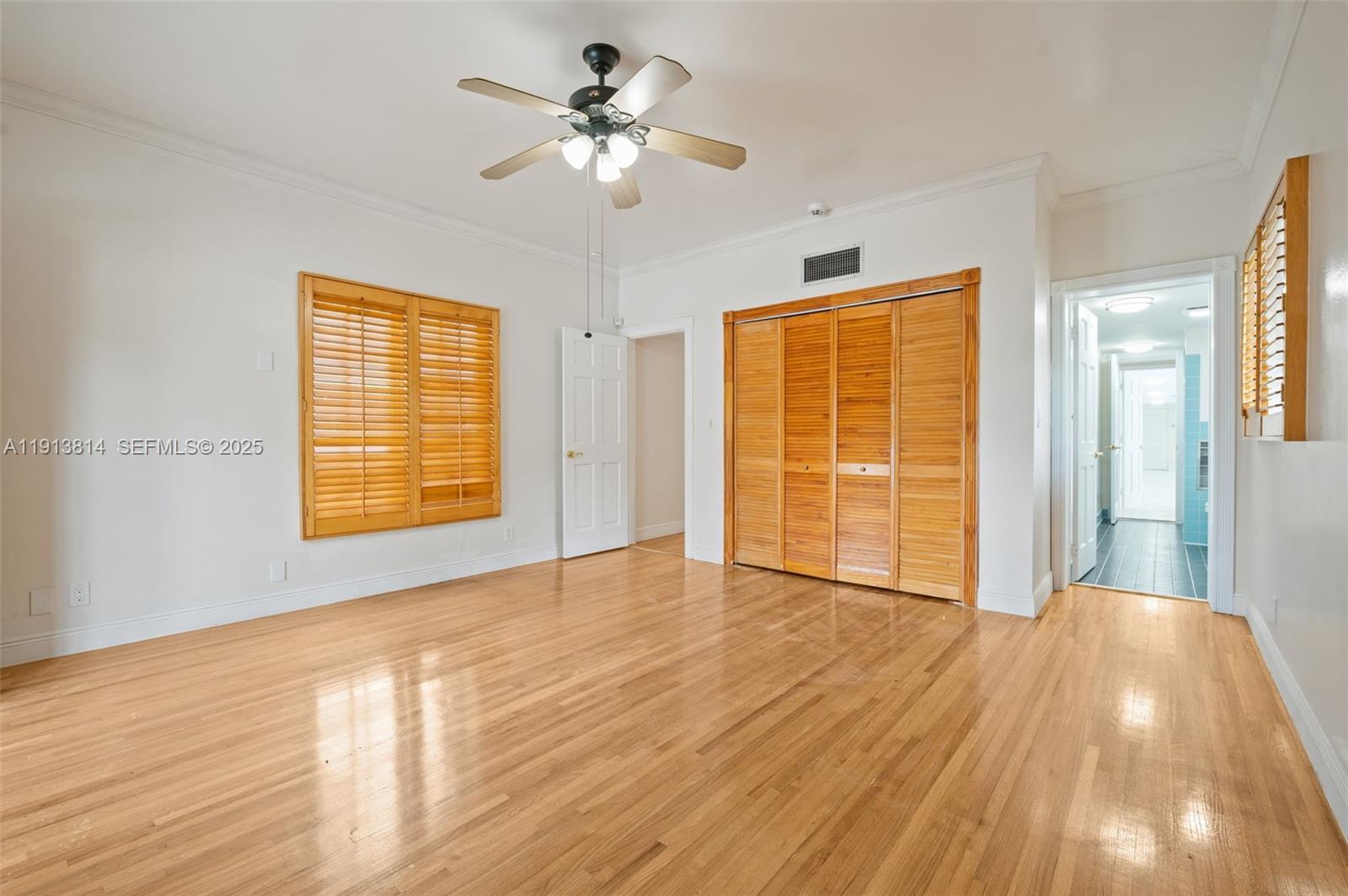 13000 Old Cutler Road Pinecrest, FL 33156 - Photo 21 of 45 a view of an empty room with a window and wooden floor