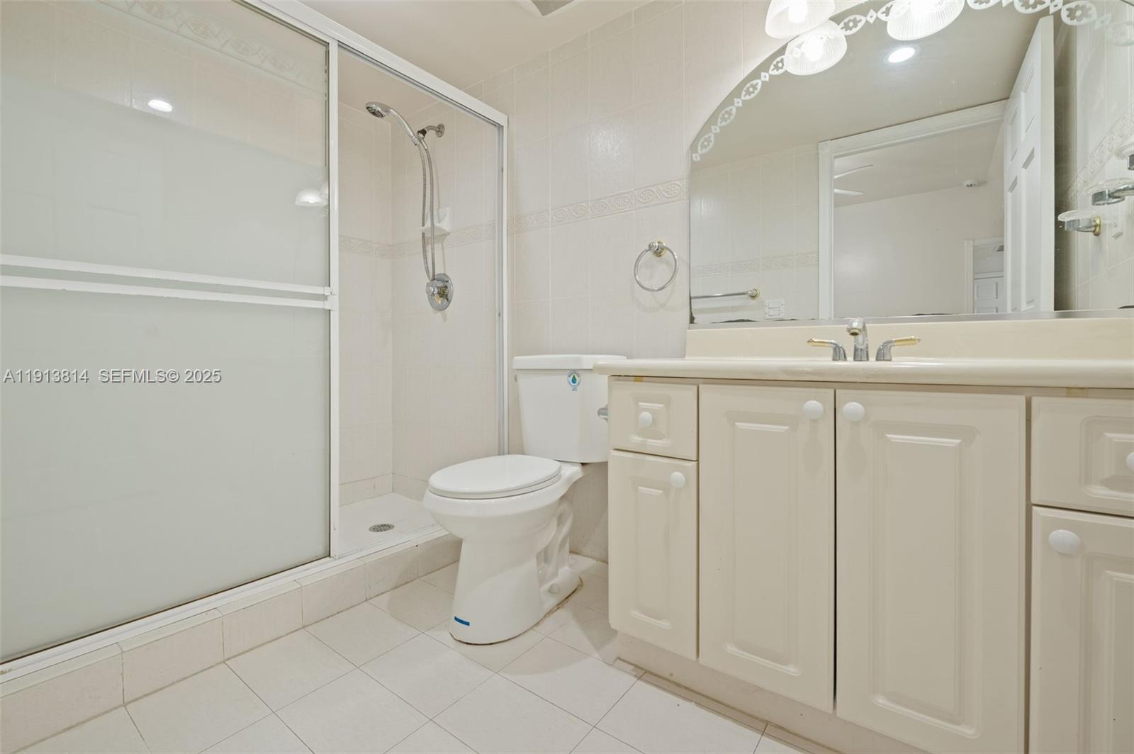 13000 Old Cutler Road Pinecrest, FL 33156 - Photo 24 of 45 a bathroom with a toilet sink and a mirror