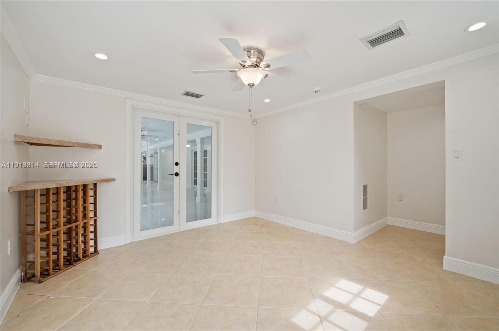 13000 Old Cutler Road Pinecrest, FL 33156 - Photo 25 of 45 a view of an empty room with a ceiling fan