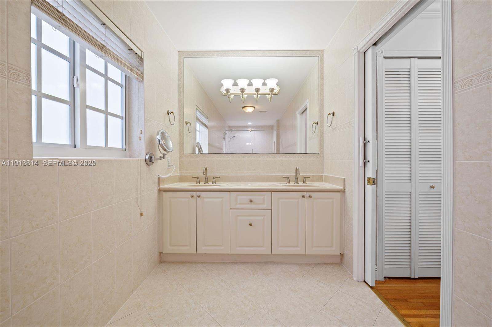13000 Old Cutler Road Pinecrest, FL 33156 - Photo 28 of 45 a spacious bathroom with a granite countertop sink a mirror and a bathtub