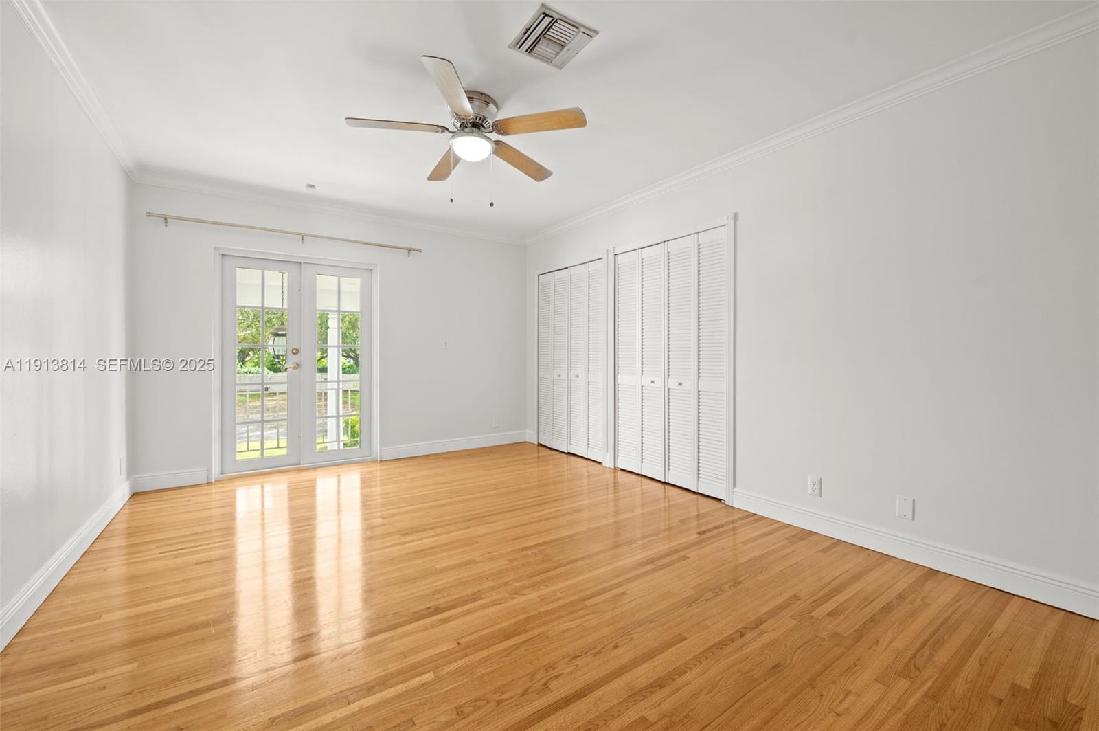 13000 Old Cutler Road Pinecrest, FL 33156 - Photo 30 of 45 a view of an empty room with wooden floor and a window