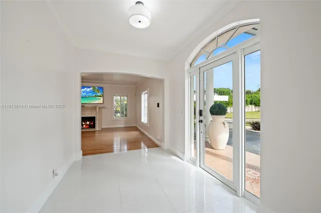 a view of a kitchen with a refrigerator a sink and a chandelier