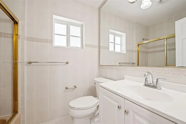 a kitchen with stainless steel appliances granite countertop a sink and cabinets with wooden floors