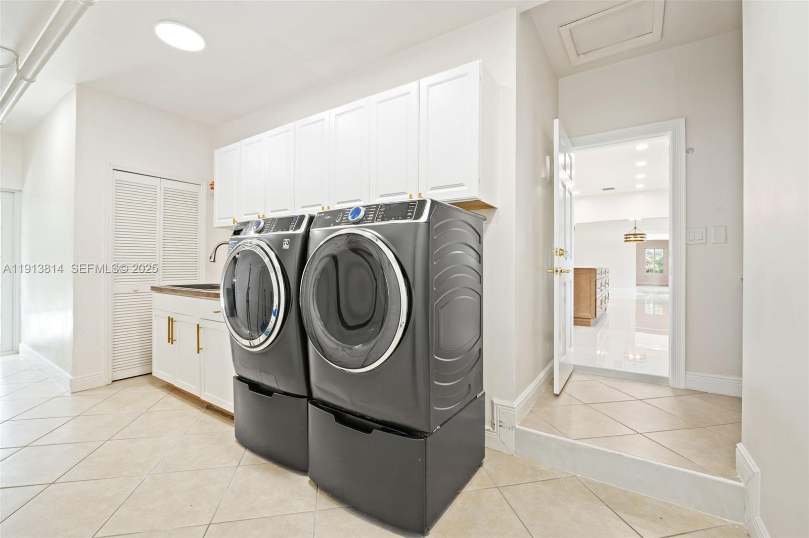 13000 Old Cutler Road Pinecrest, FL 33156 - Photo 34 of 45 a utility room with dryer and washer