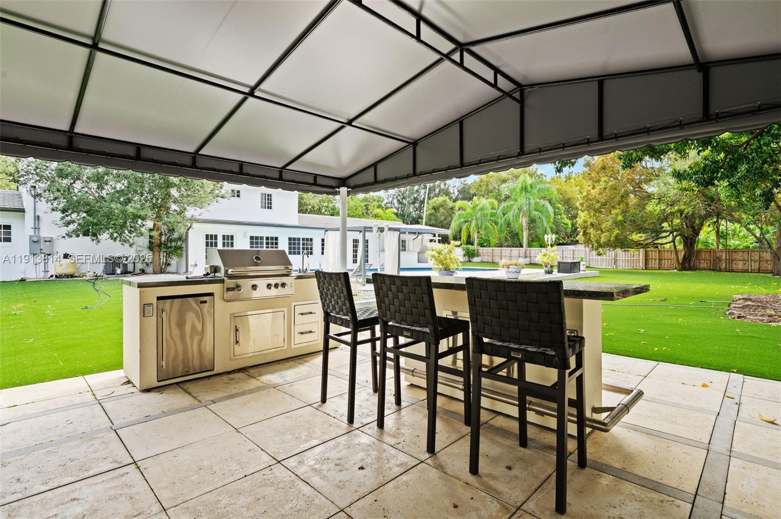 13000 Old Cutler Road Pinecrest, FL 33156 - Photo 37 of 45 a table and chairs in the garden