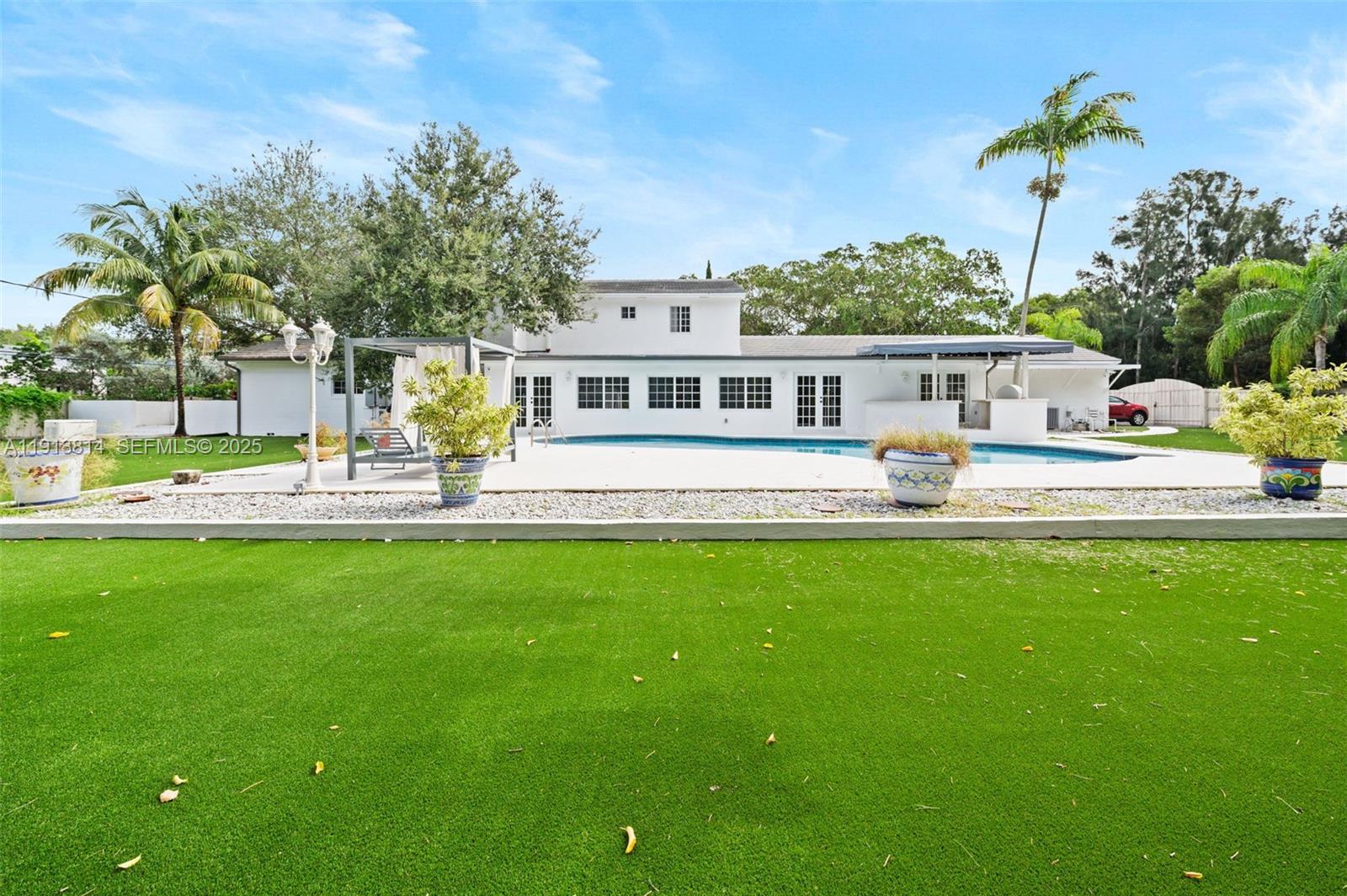 13000 Old Cutler Road Pinecrest, FL 33156 - Photo 38 of 45 a front view of a house with garden