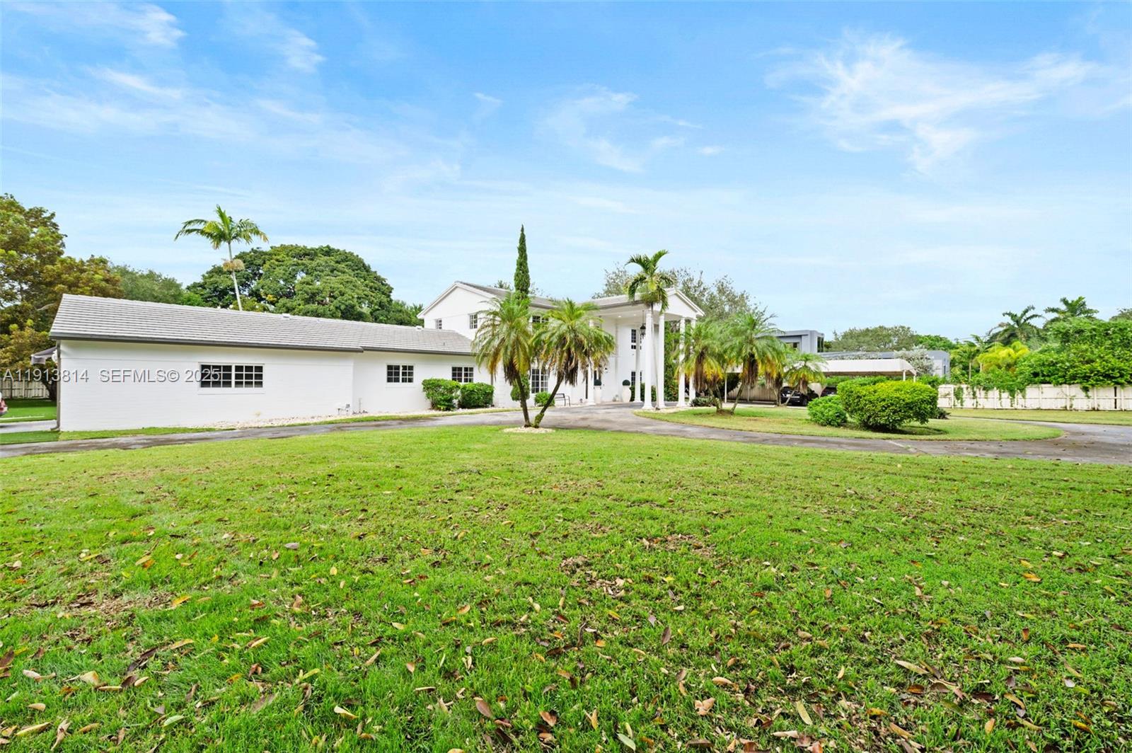 13000 Old Cutler Road Pinecrest, FL 33156 - Photo 44 of 45 a front view of house with yard and green space